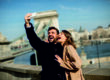 Portrait of loving couple taking selfie in urban enviroment