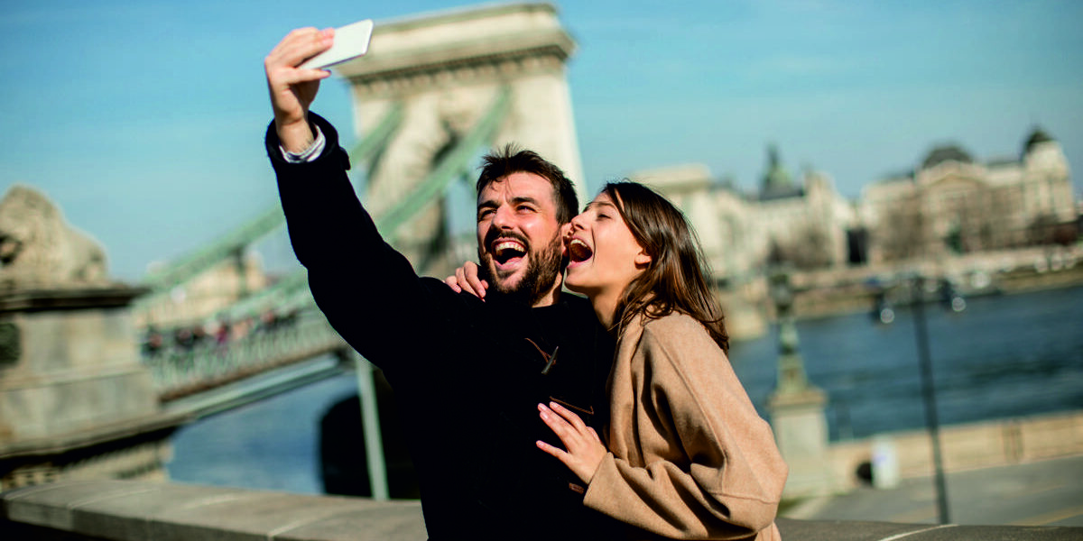 Portrait of loving couple taking selfie in urban enviroment