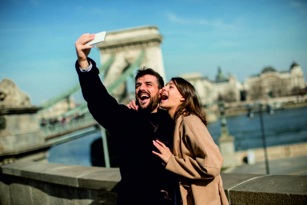 Portrait of loving couple taking selfie in urban enviroment